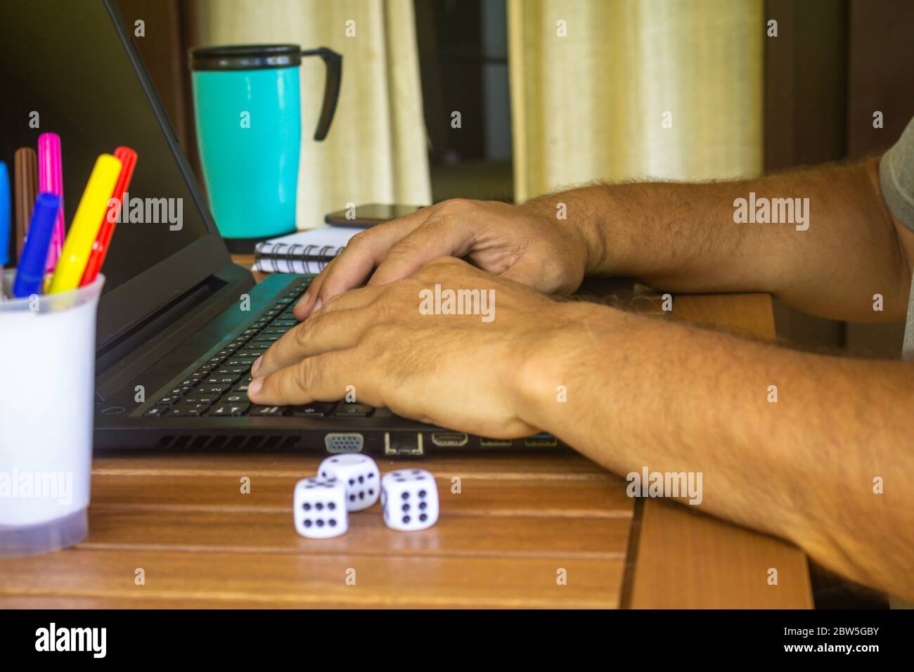 Man doing computer work from home during quarantine. Social isolation of office workers. Pandemic teleworking concept Stock Photo