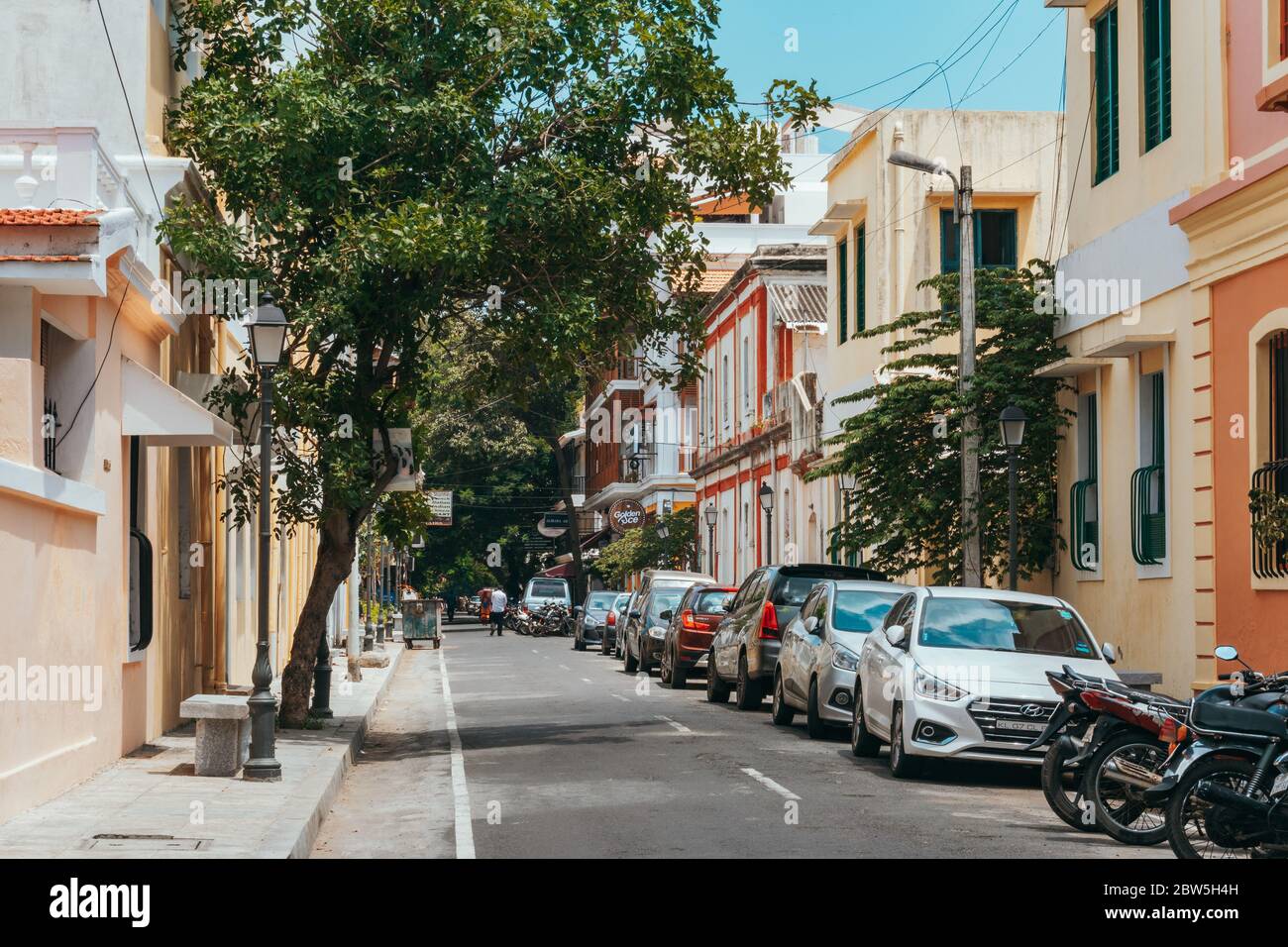 An ornate street filled with pastel-colored buildings in the old French colonial town of White Town, Pondicherry, on India's east coast Stock Photo