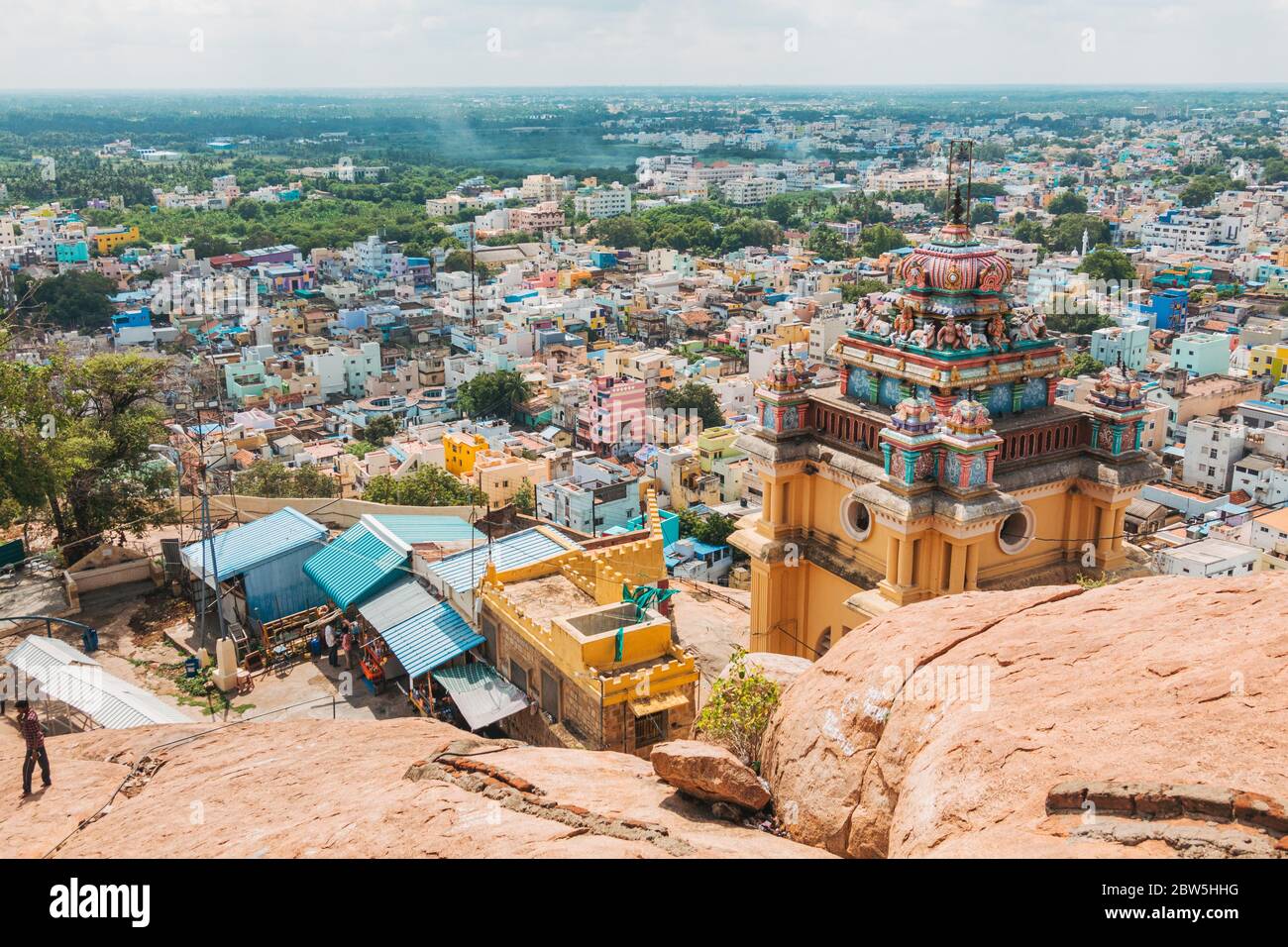 Views out over the colorful city of Tiruchirappalli from the Rock Fort, Thayumanaswami Temple can be seen in the foreground Stock Photo