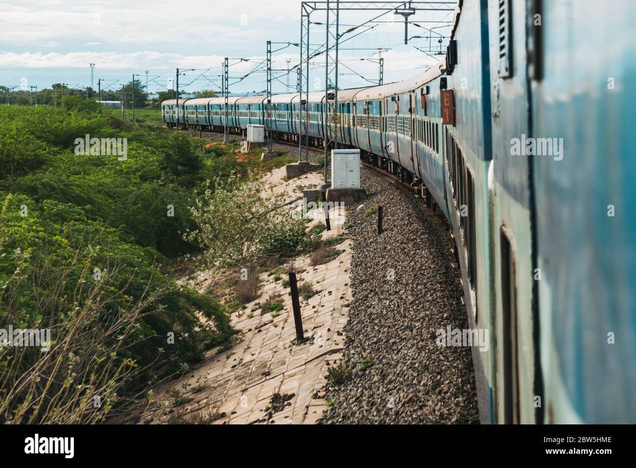 The view of the carriages from the train door as it rounds a bend approaching Madurai, Tamil Nadu, India Stock Photo