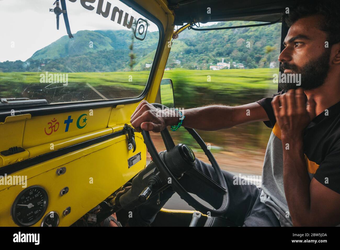 A young Indian male jeep tourist taxi driver in Munnar, Kerala, India Stock Photo