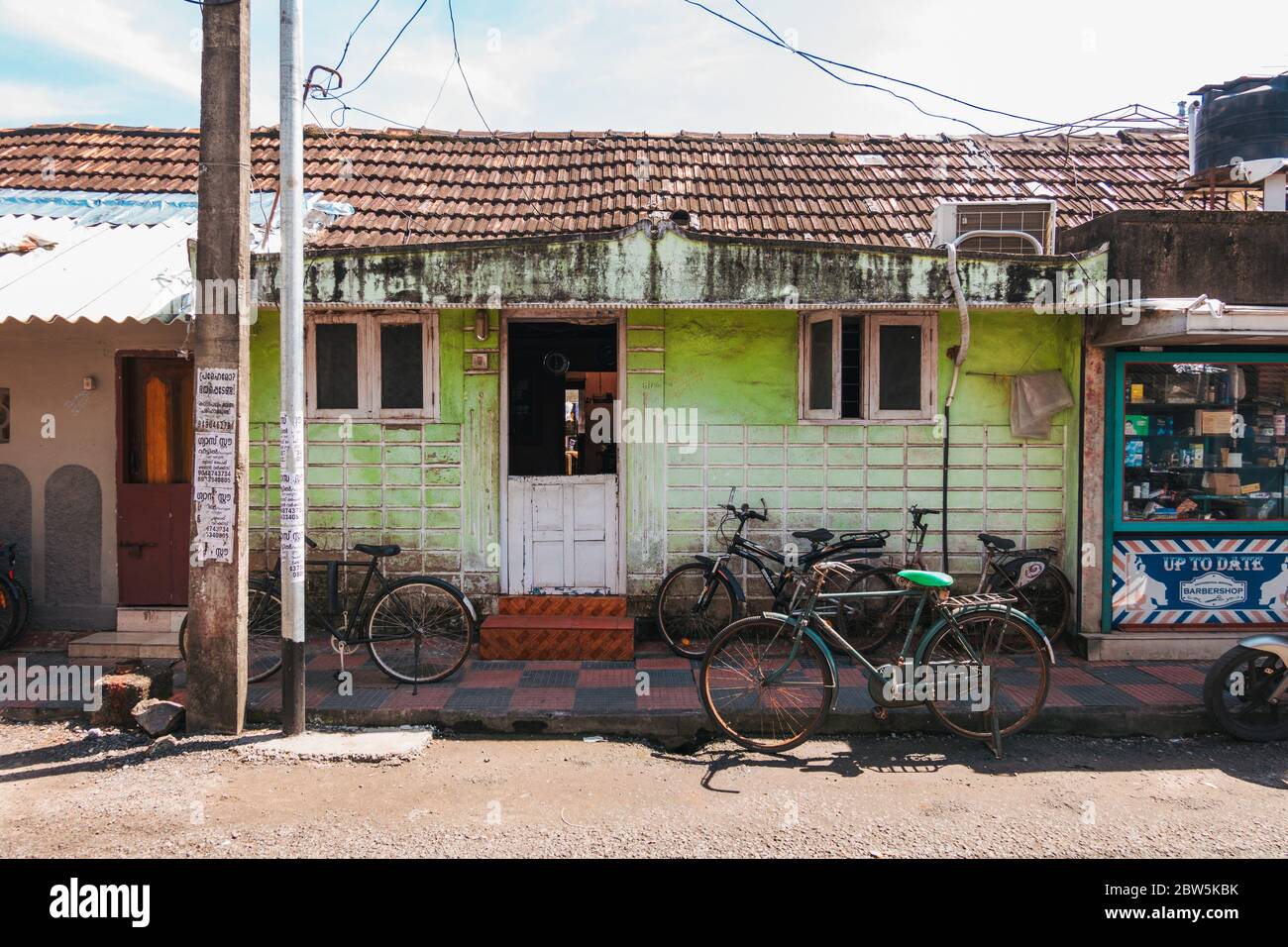 Bicycles Parked In Front Of A Small House On A Street In Kochi India