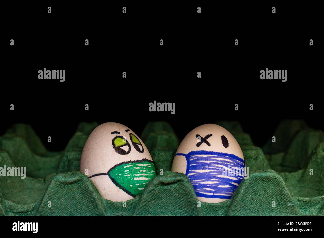 Representation of faces with chinstraps in eggs. Eggs with human expressions with nose and mouth protection. Free space to write. Concept of protectio Stock Photo