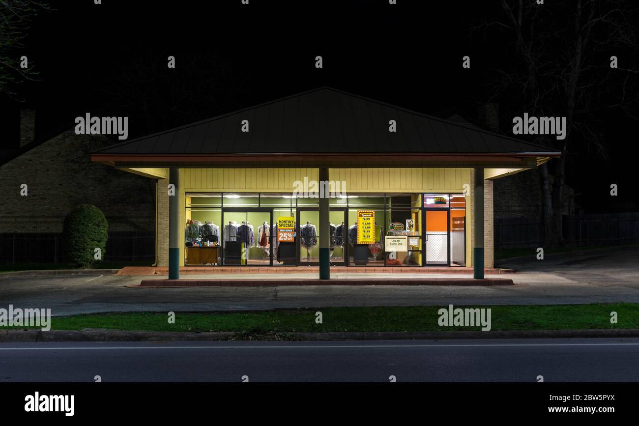 Dry cleaning business storefront at night Stock Photo