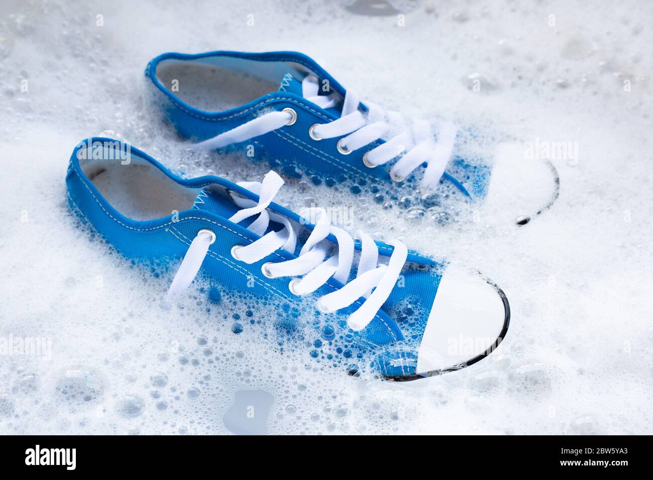 Soak shoes before washing. Cleaning Dirty sneakers Stock Photo - Alamy