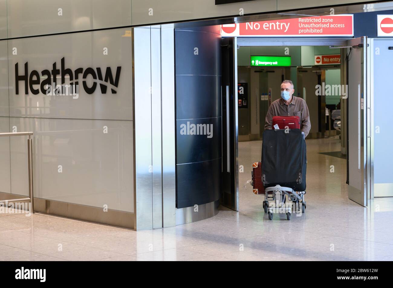 English man returning to Heathrow Terminal 2 on the penultimate repatriation flight, organised by the UK Government from Lagos Nigeria. Stock Photo