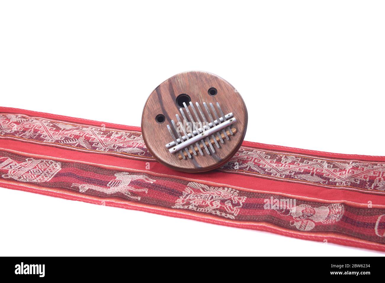 African folk music instrument kalimba on red cloth with white background Stock Photo