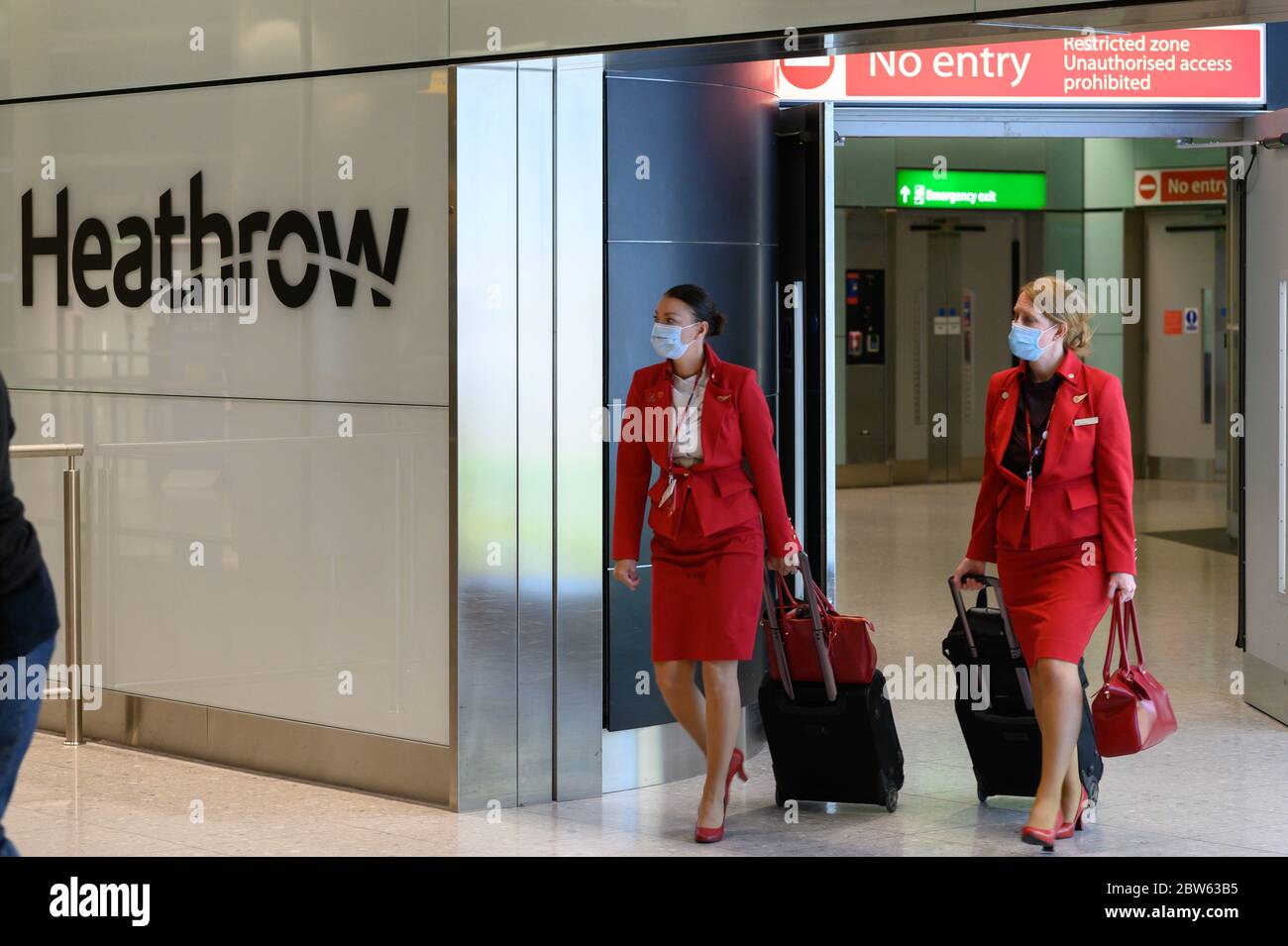 British passengers and flight attendants pushing luggage, arrive at
