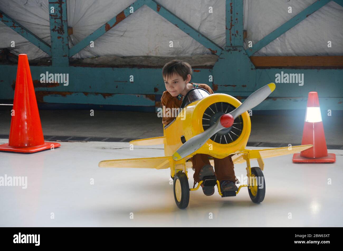 Boy driving a peddle-powered airplane Stock Photo