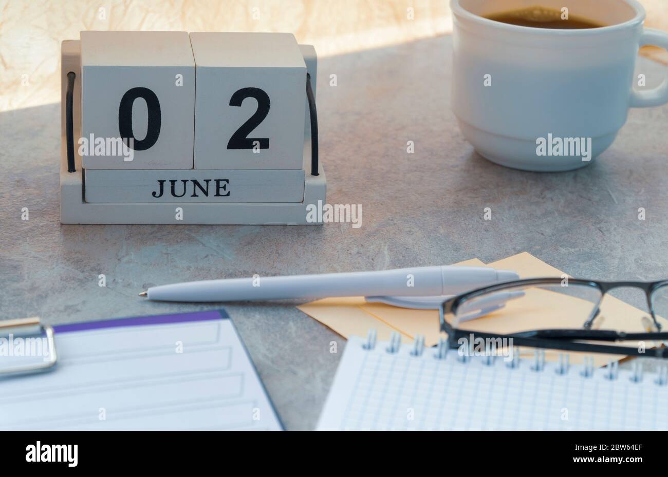 June 02, date on the calendar. Handmade wood cube with date month and ...