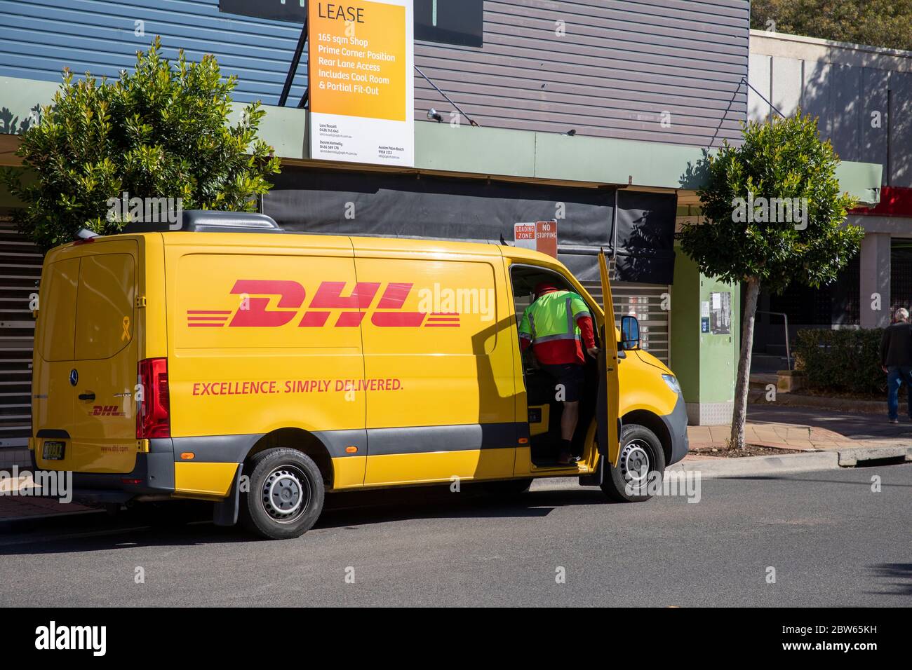 DHL delivery truck in Sydney Australia with delivery driver getting into vehicle,Australian Stock Photo