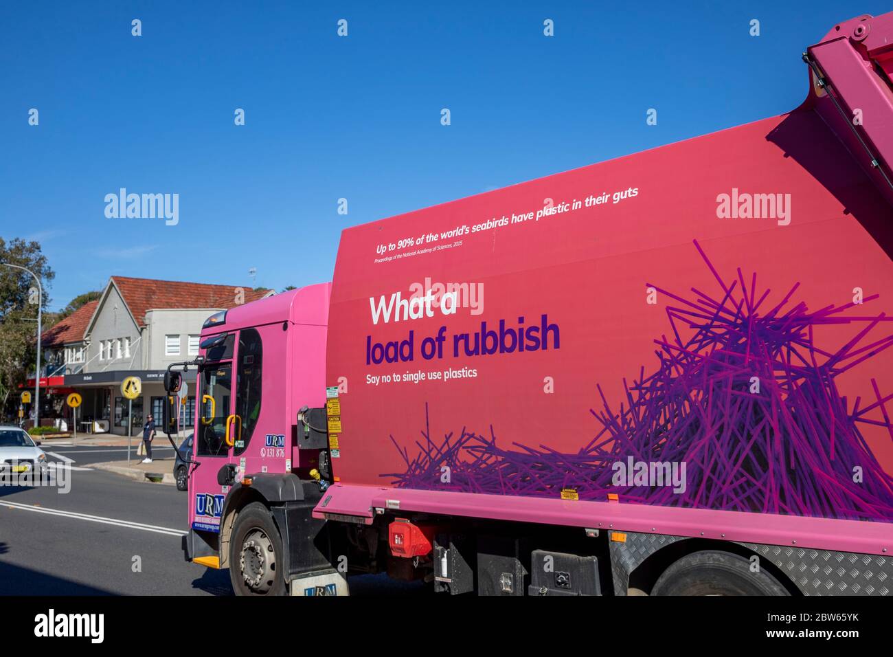Pink garbage waste rubbish collection truck displaying what a load of