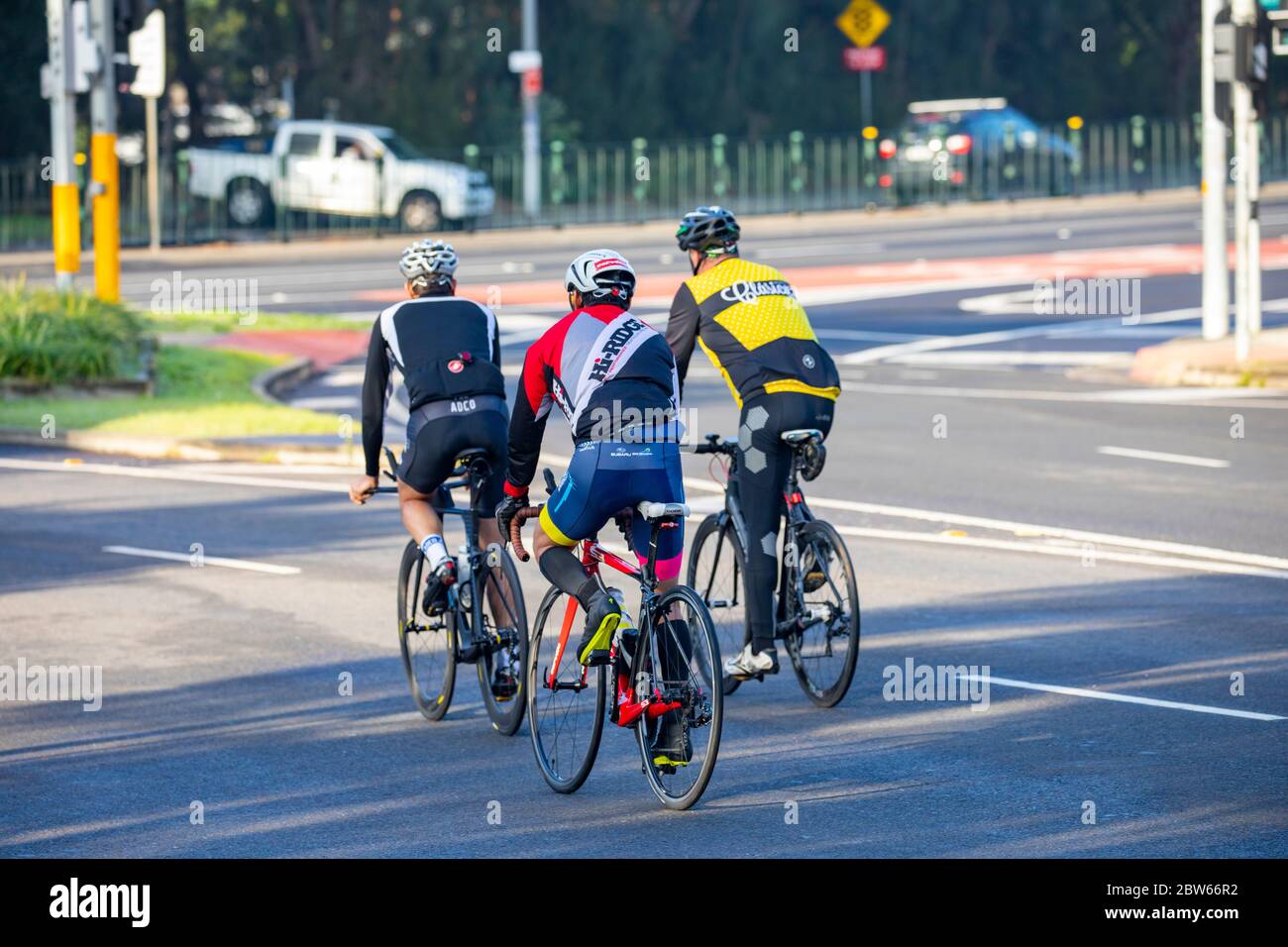Cyclists wearing helmets on the roads of Sydney riding their road