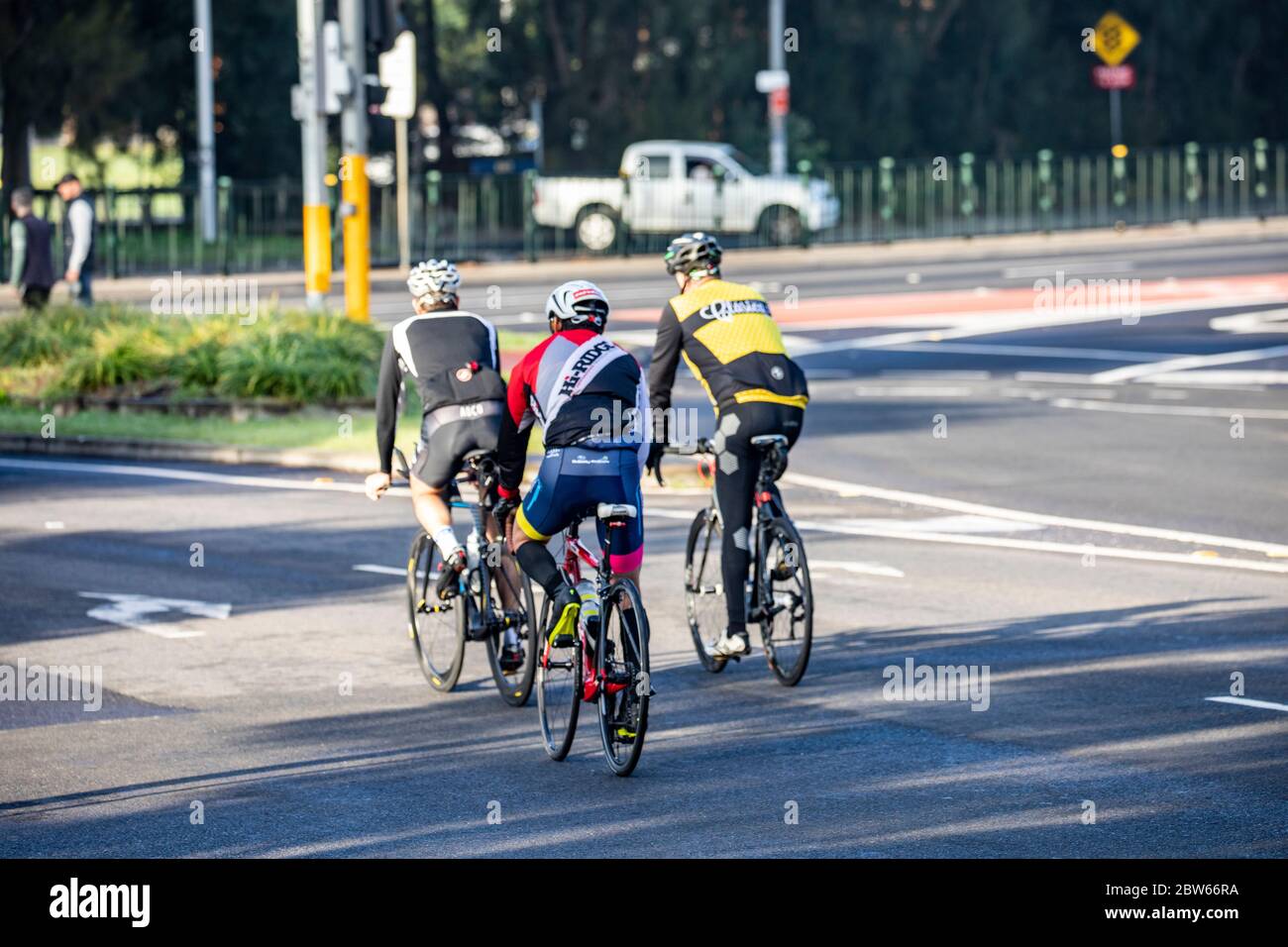 Road cycling three male bike riders cycling on the road in north Sydney,NSW,Australia Stock Photo