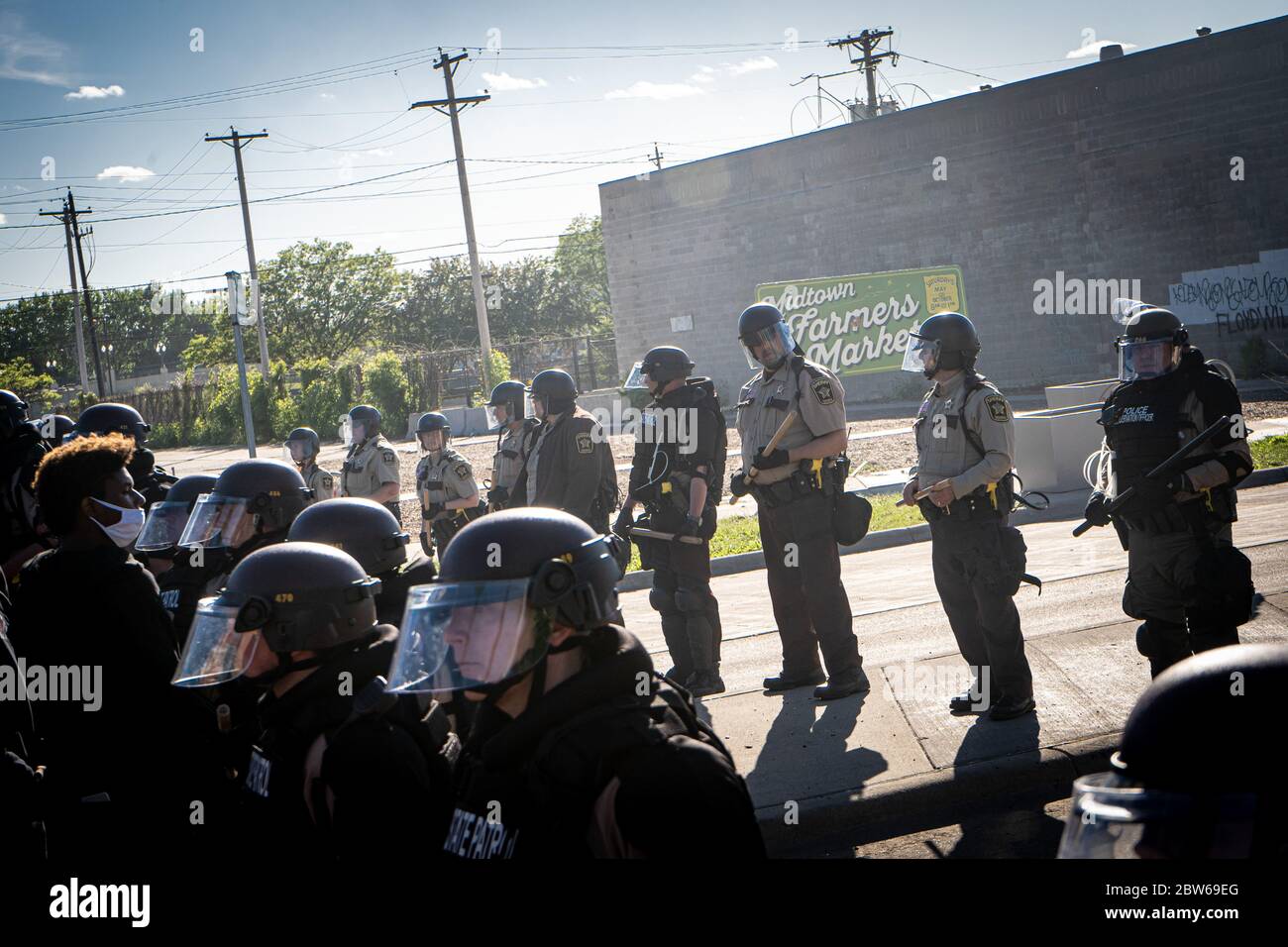 Smiling Riot Police state patrol police officers standing guard towards minneapolis riots ...