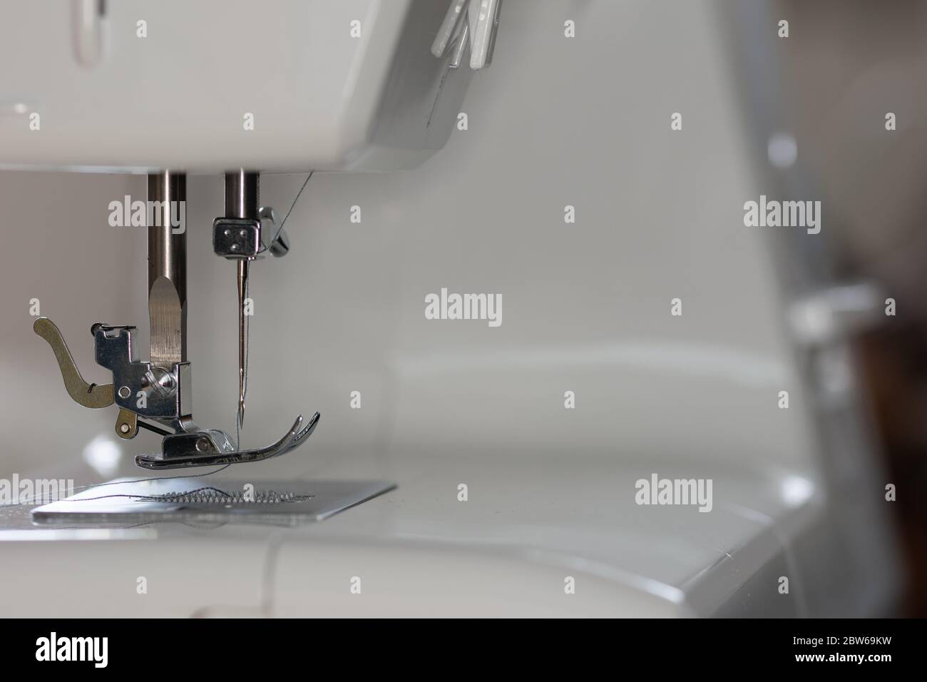 Readytouse sewing machine in detail with inserted threads and spool