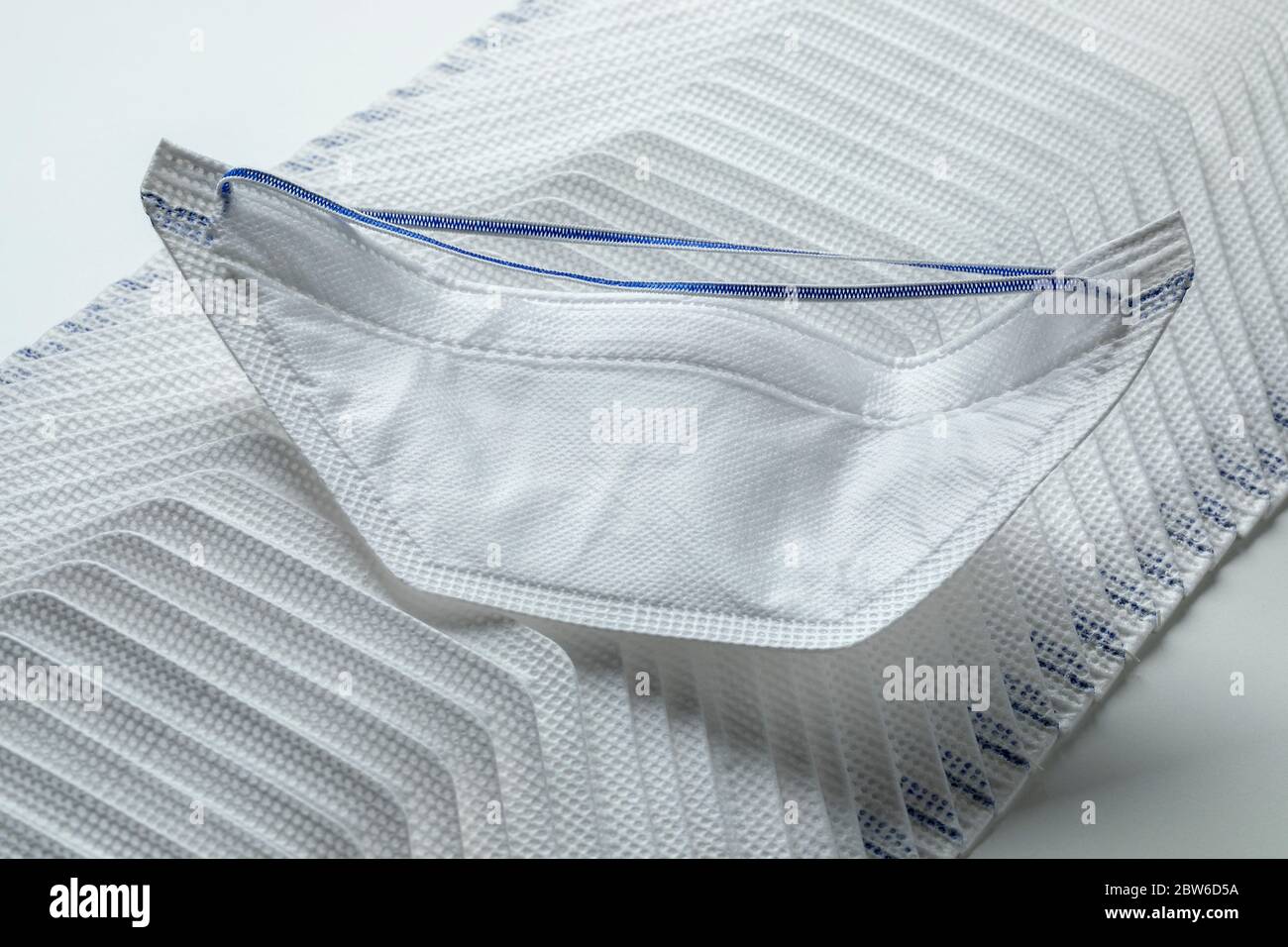 Row of medical protective face masks on white background Stock Photo