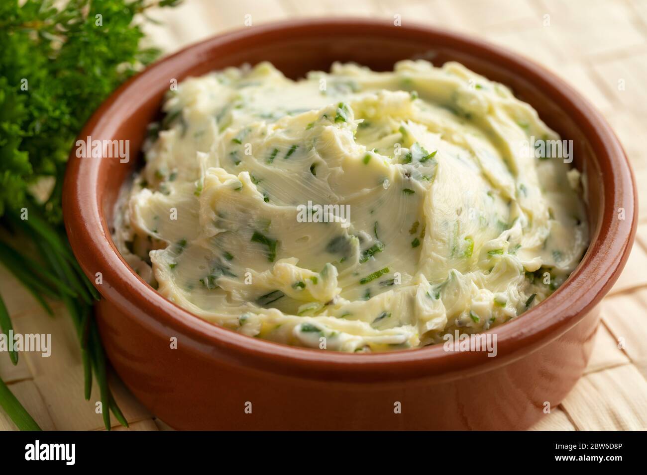 Bowl with fresh made herb butter close up Stock Photo