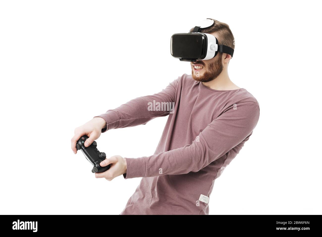 Young man using virtual reality glasses and playing video game on white ...