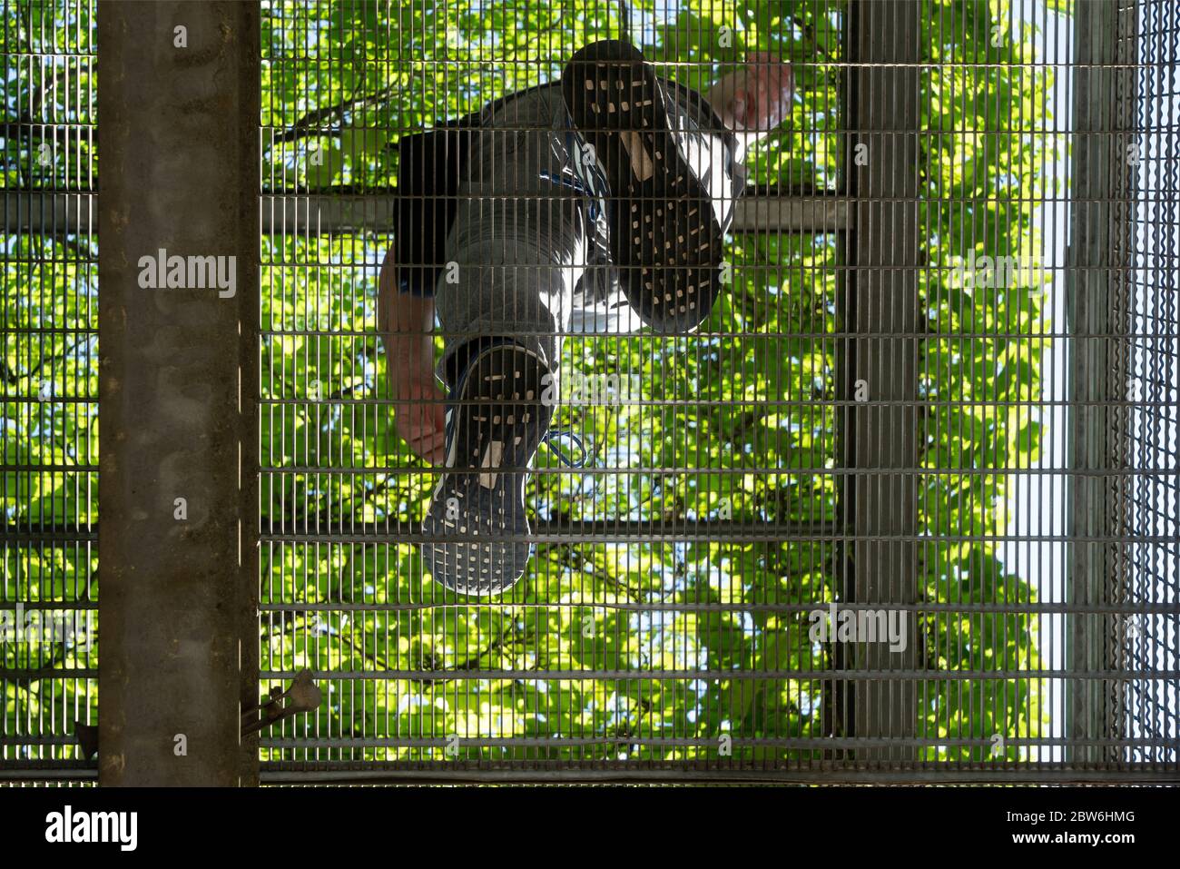 the passage of a man in a metal walkway shot from below Stock Photo