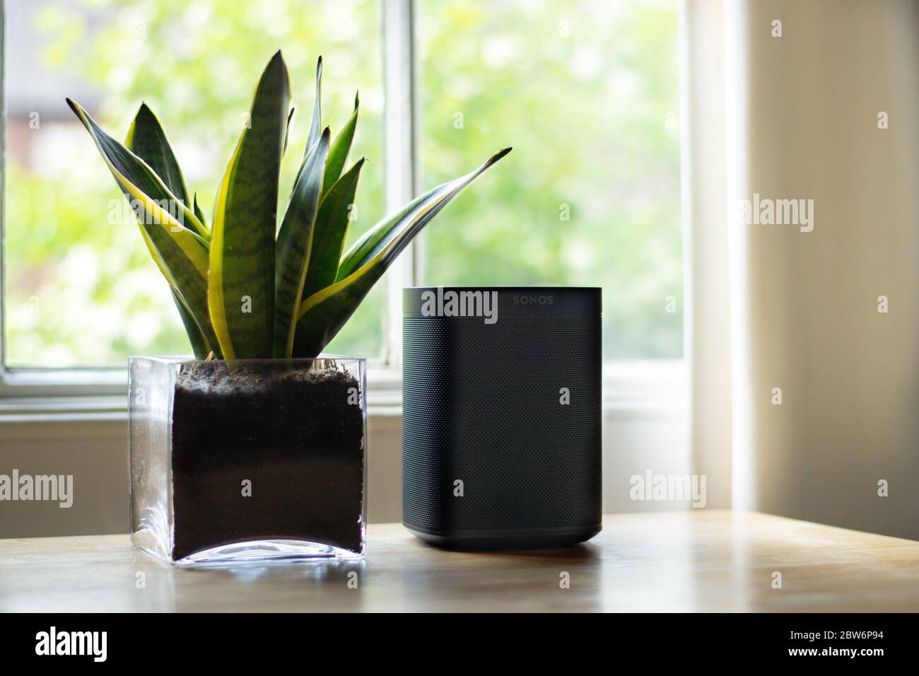 London, United Kingdom - May 09 2020: A Sonos speaker placed next to a plant in a beautiful home. Stock Photo