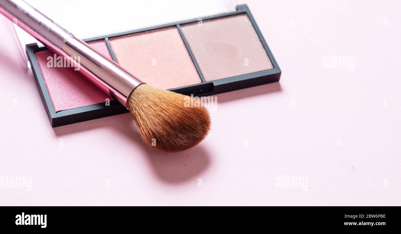 Blush powder pallete set pastel colors and brush against pink background, closeup view. Professional tools for make up, beauty salon, cosmetics concep Stock Photo