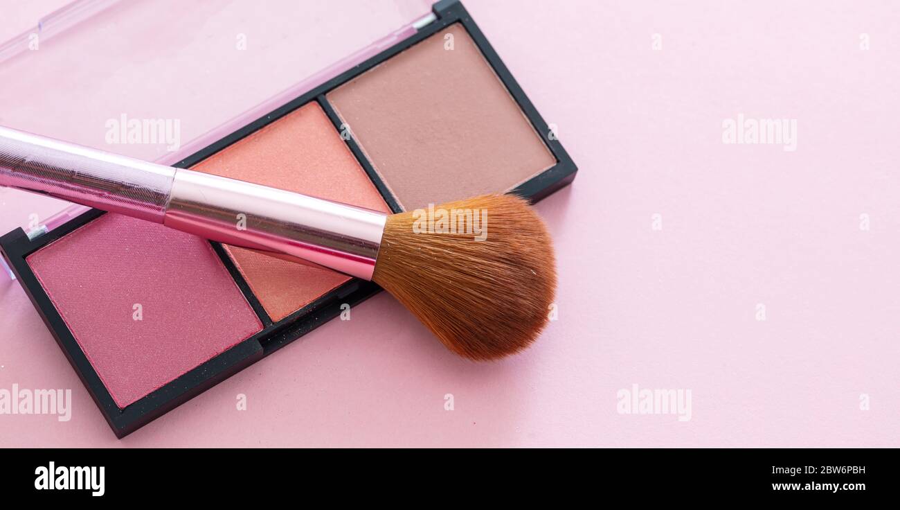 Blush powder pallete set pastel colors and brush against pink background, closeup view. Professional tools for make up, beauty salon, cosmetics concep Stock Photo