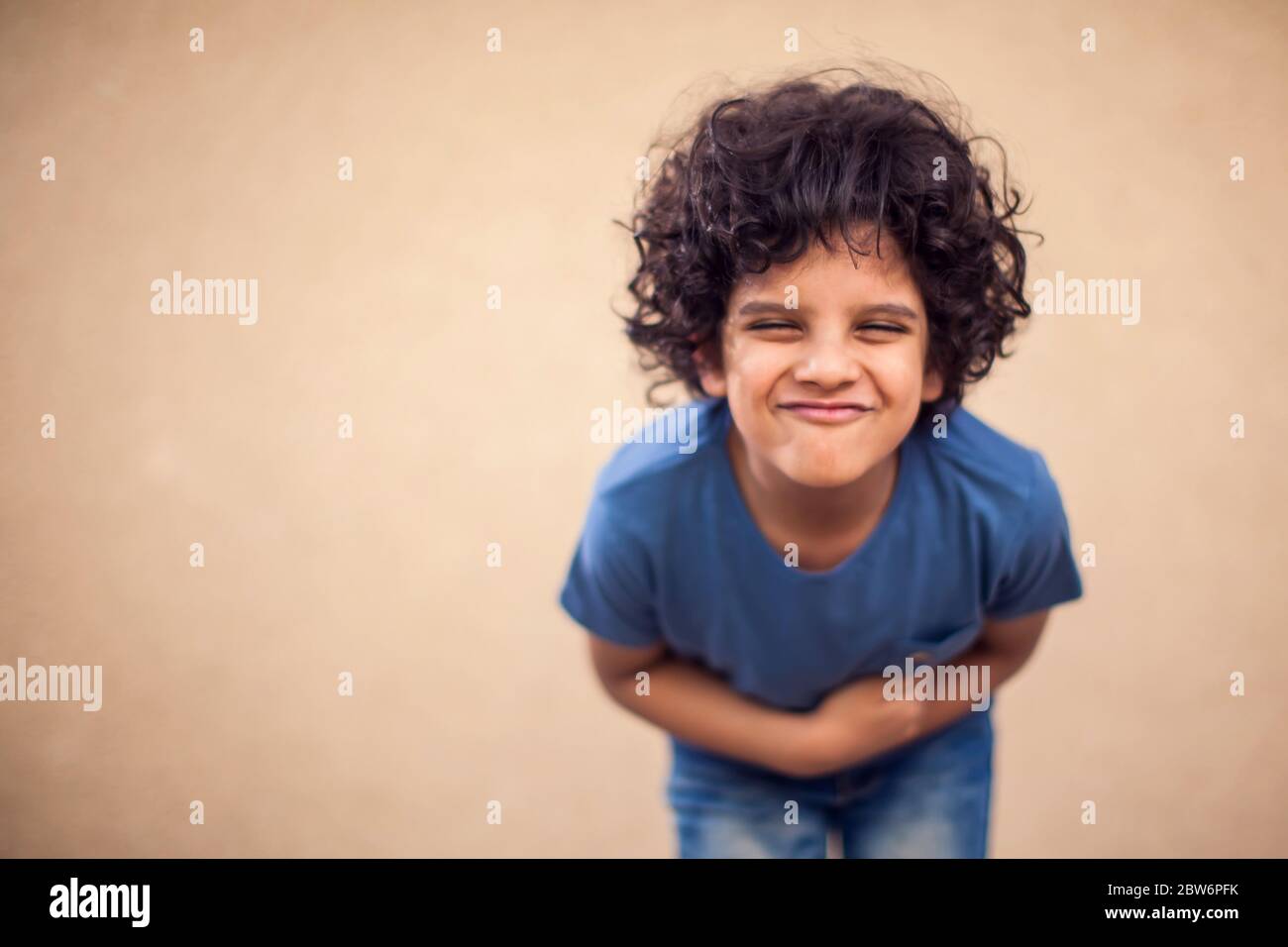 Kid boy feels strong stomach ache. Children, healthcare and medicine concept Stock Photo