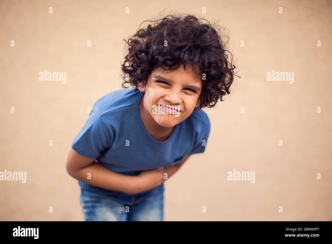 Kid boy feels strong stomach ache. Children, healthcare and medicine concept Stock Photo