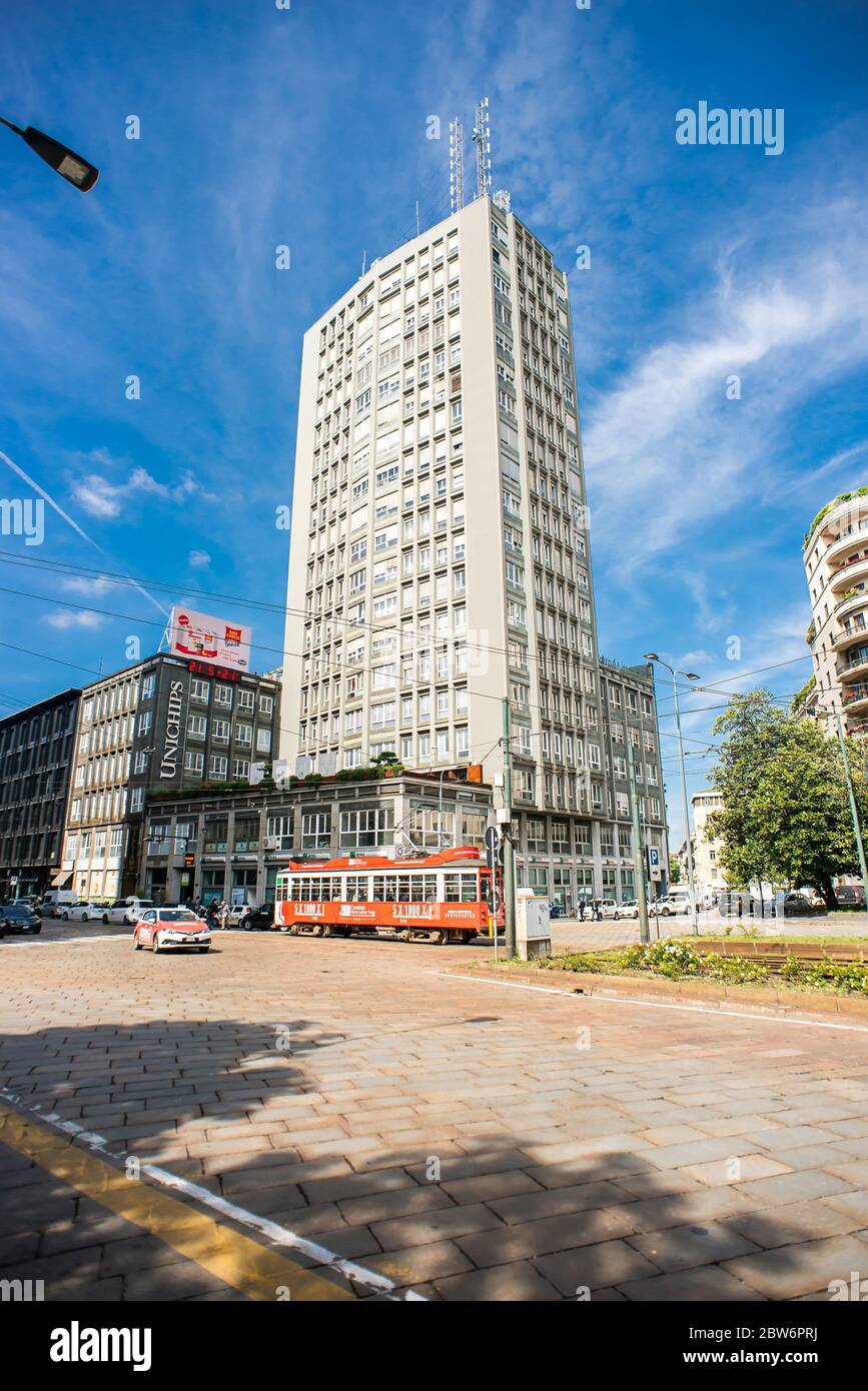 Milan. Italy - May 21, 2019: High Building on Street Piazza della Repubblica in Milan. Red Tram Next to Building. Stock Photo