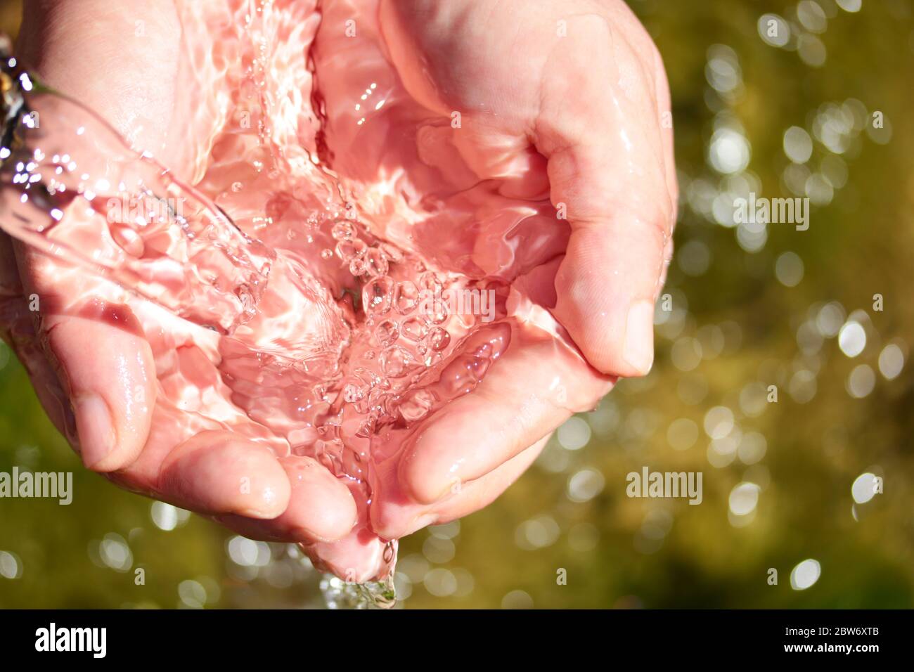 natural spring water in the hands Stock Photo Alamy