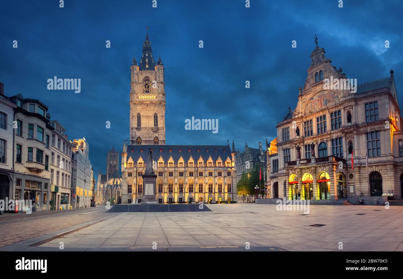 Ghent, Belgium. Sint-Baafsplein square at dusk with building of historic Town Hall and famous Belfry of Ghent Stock Photo