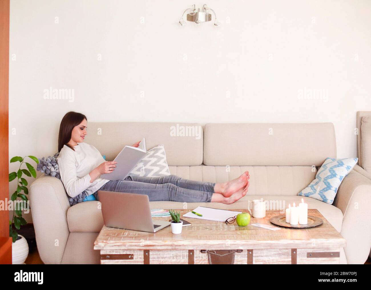 Barefoot girl lying on sofa hi-res stock photography and images - Alamy