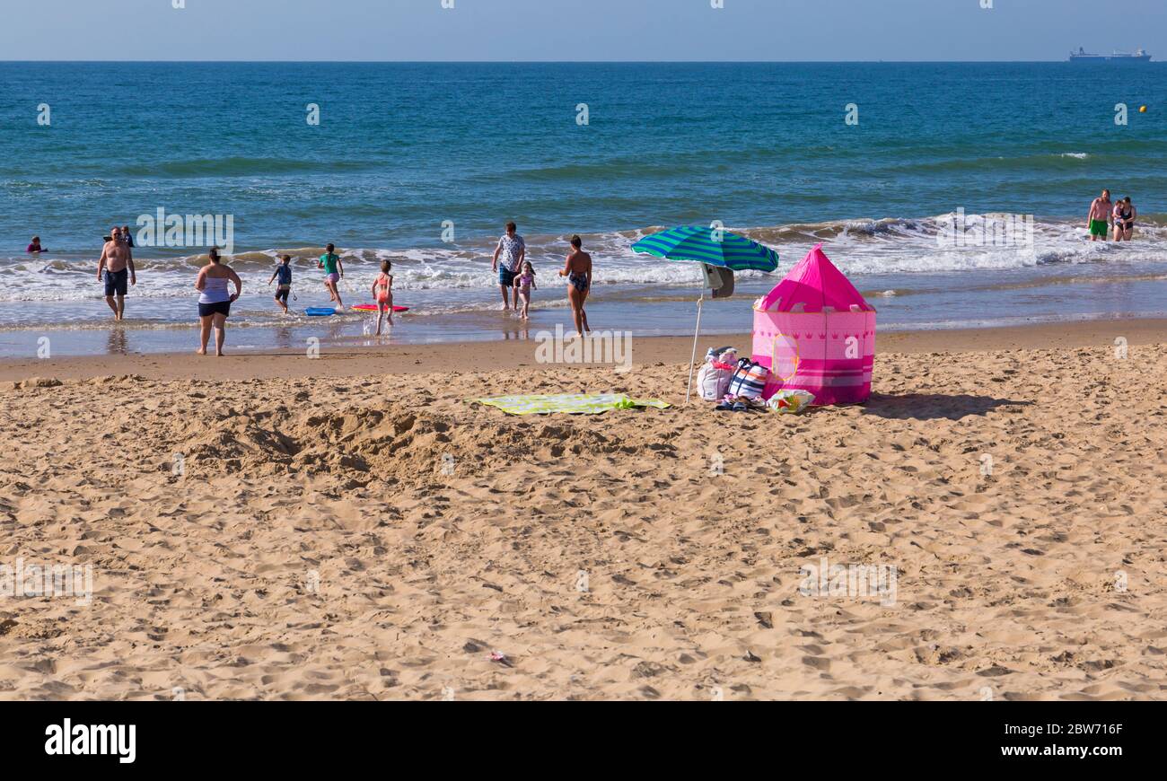 Bournemouth, Dorset UK. 30th May 2020. UK weather: hot sunny day at Bournemouth beaches as the glorious weather continues and temperatures rise with clear blue skies and unbroken sunshine. Sunseekers head to the seaside early to get a good spot and enjoy the sunshine, as the beaches are expected to get packed later. Credit: Carolyn Jenkins/Alamy Live News Stock Photo