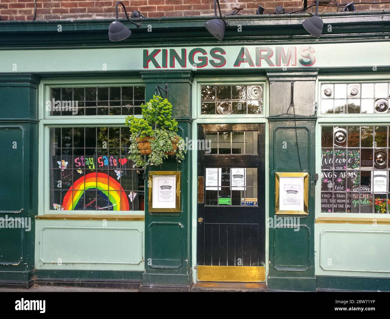 London, United Kingdom - May 08, 2020: Colourful rainbow as sign of gratitude to NHS and key workers displayed on Kings Arm pub in Greenwich. Bars & r Stock Photo