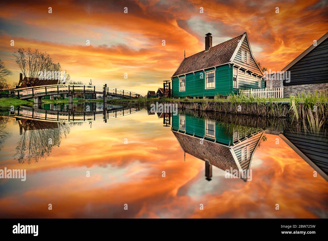 Reflection of the wooden green houses topped with dark orange color