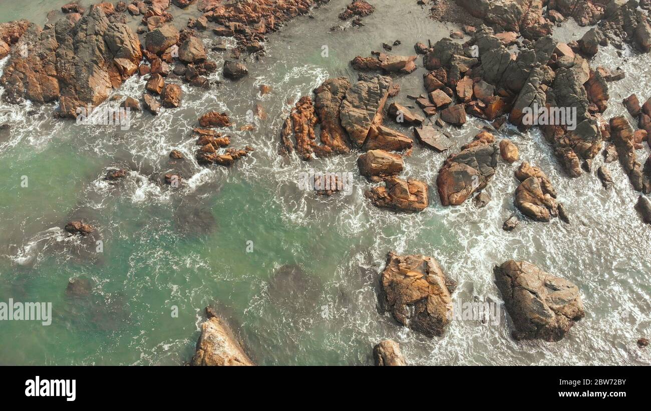 Aerial view rocks and stones on the Arambol beach in North Goa, India ...