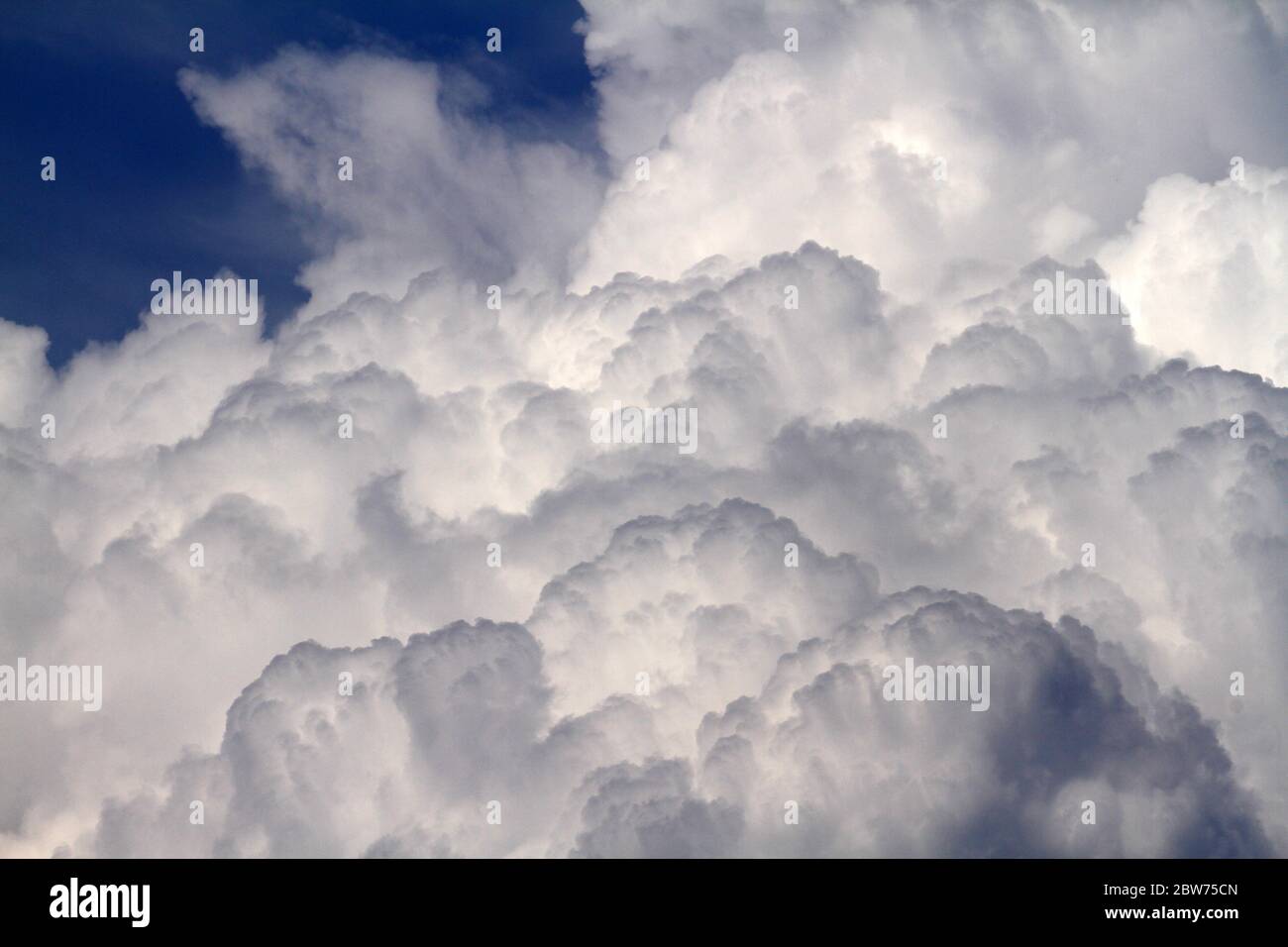 Blue sky background with white fluffy clouds Stock Photo - Alamy