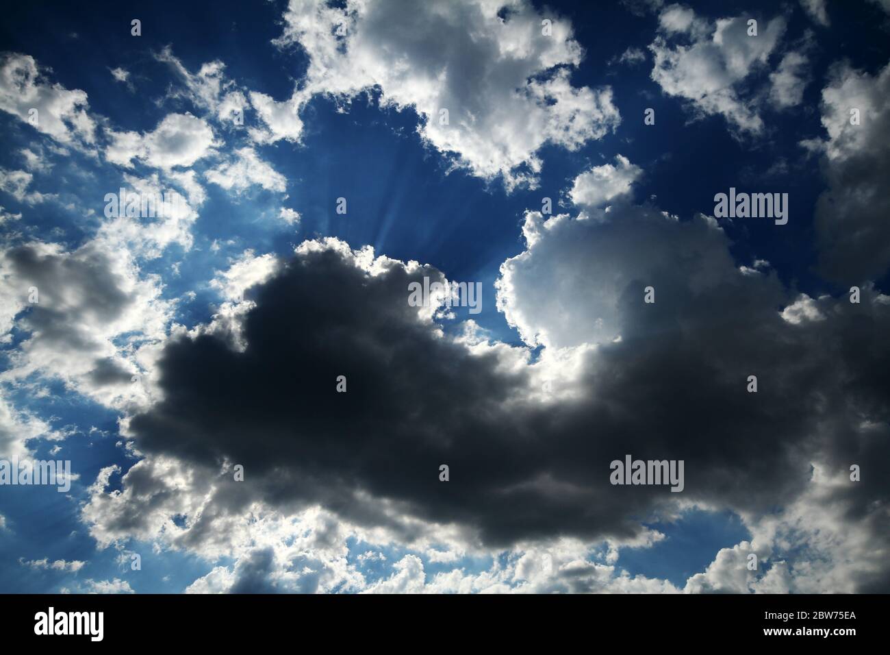 Blue sky background with white fluffy clouds Stock Photo - Alamy