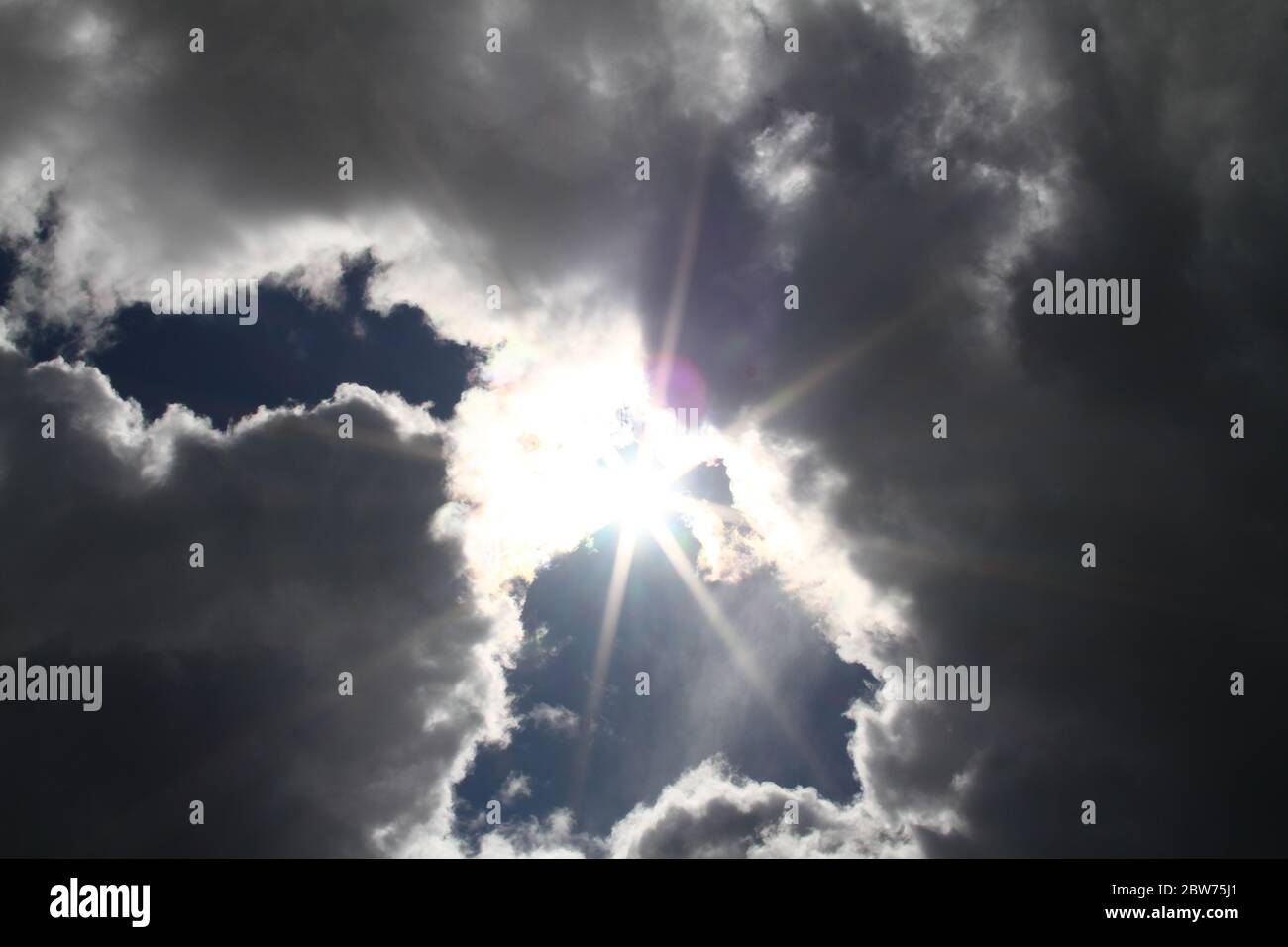 Blue sky background with white fluffy clouds Stock Photo - Alamy