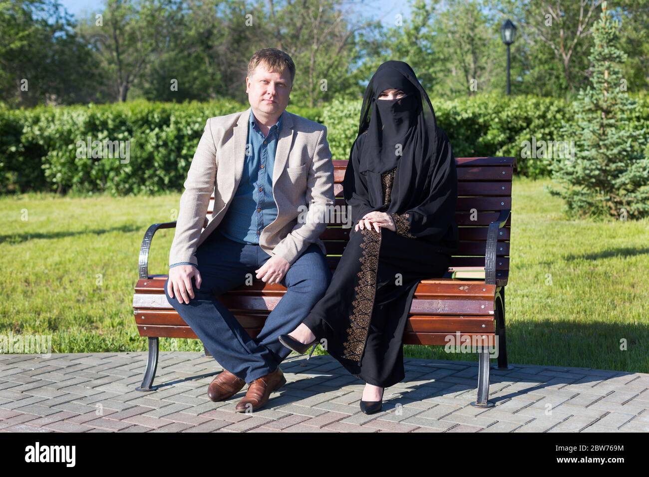The friendship of a European man and a Muslim woman. Stock Photo