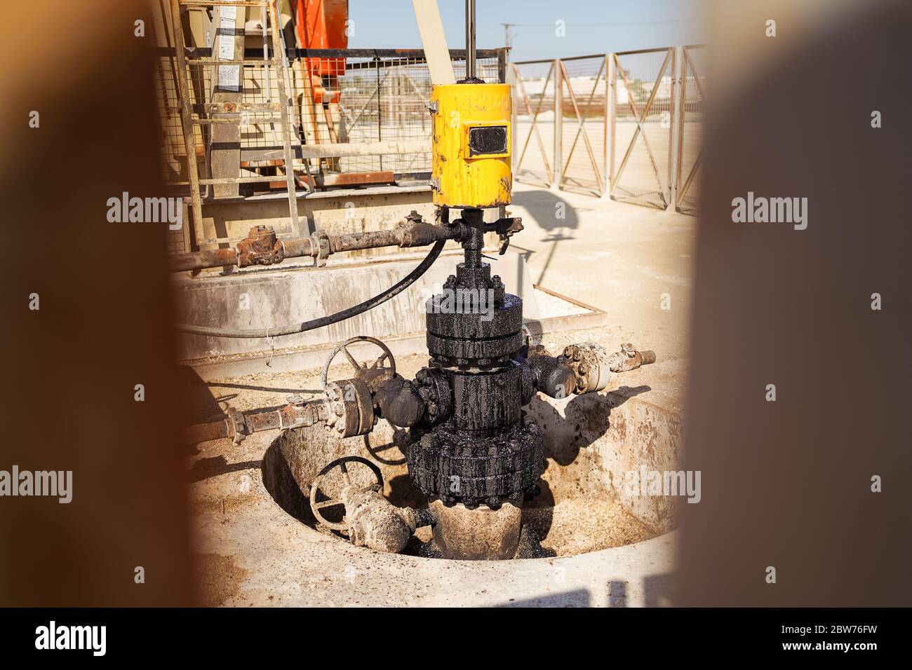 Bahrain city / Bahrain - January 15, 2020: Working oil pump jack at work in the desert Stock Photo