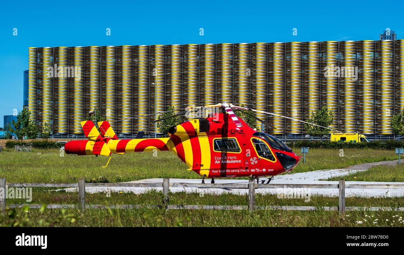 Helicopter Air Ambulance Cambridge. The  Essex & Herts Air Ambulance waits at Cambridge Addebrookes Hospital Helipad. McDonnell Douglas MD902 Explorer Stock Photo