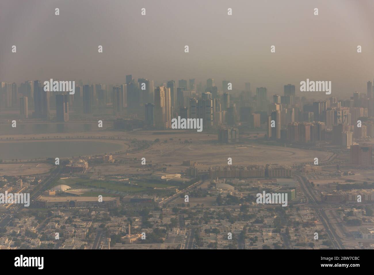 DUBAI, UAE - APRIL 29: Aerial view of Downtown Dubai and skyscrapers  during morning sandstorm. Highway and trainline, soft light over the sand Stock Photo