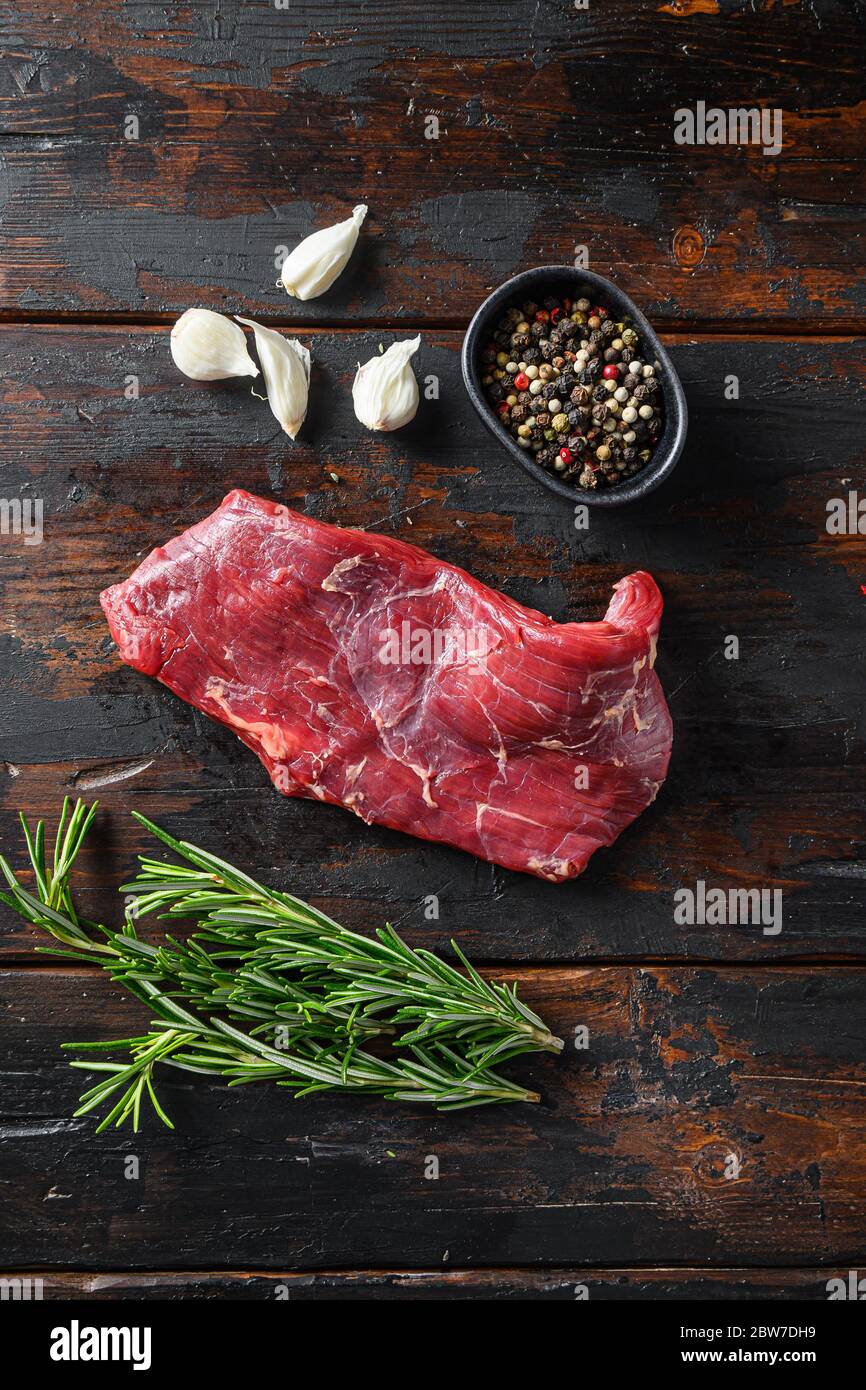 Flank, Bavette steak with seasonings, and fresh herbs raw meat, marbled
