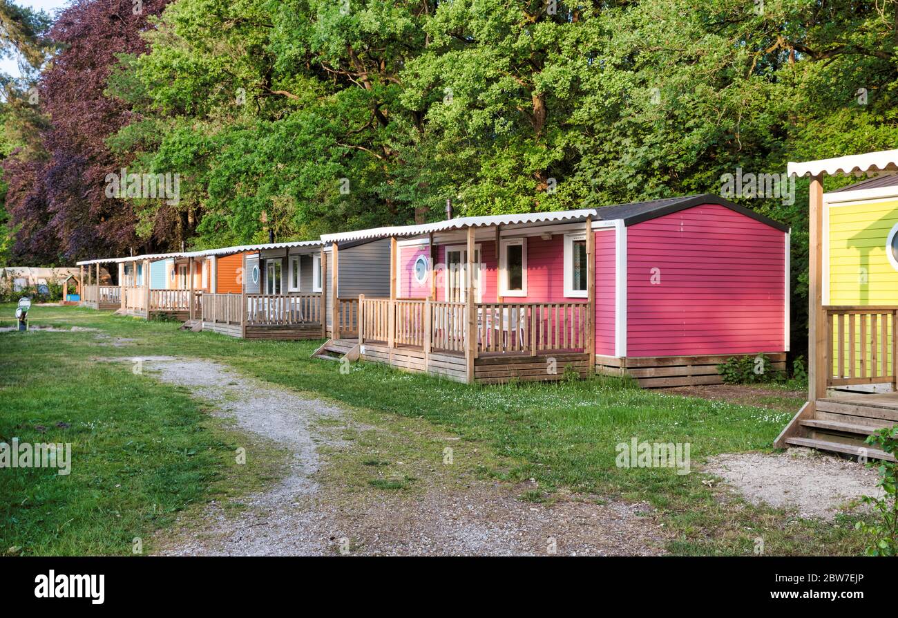 Mobile homes, yellow green orange brown pink with veranda bungalow in a