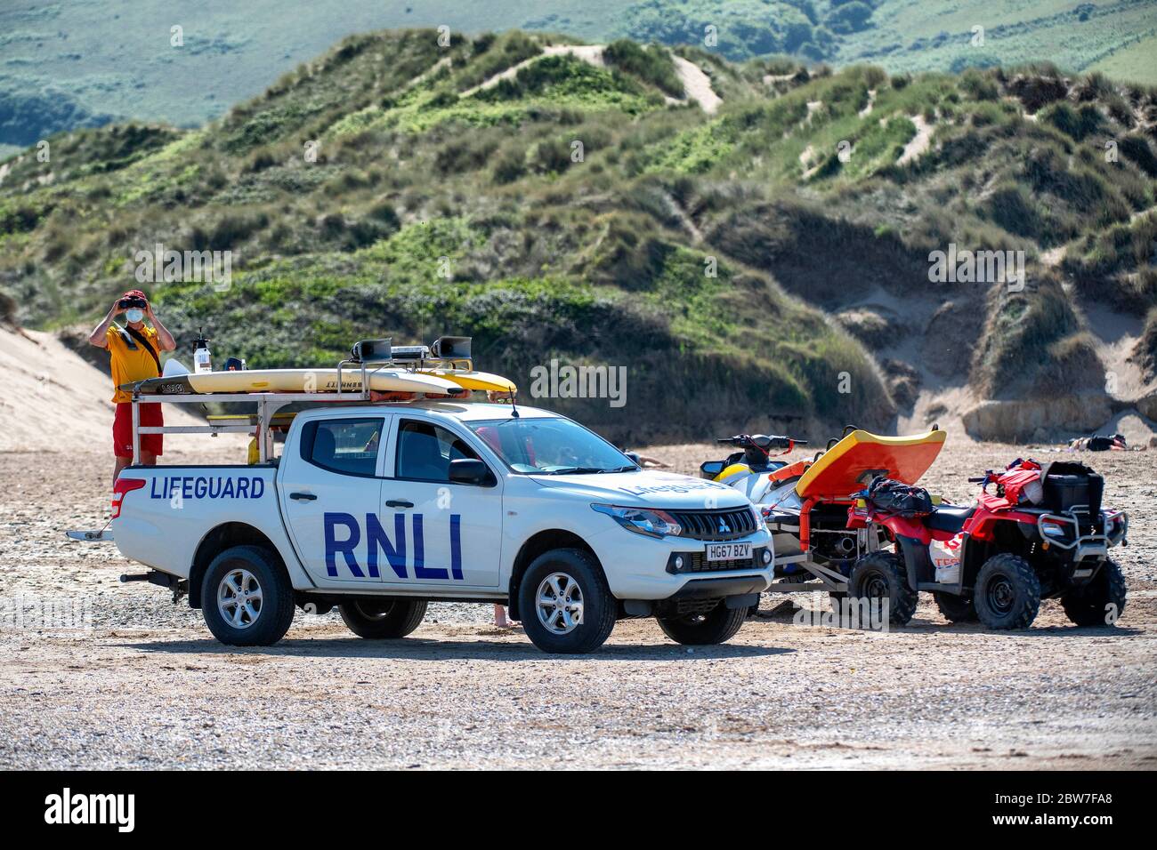 RNLI Lifeguards resume patrols on the beach at Croyde in Devon wearing