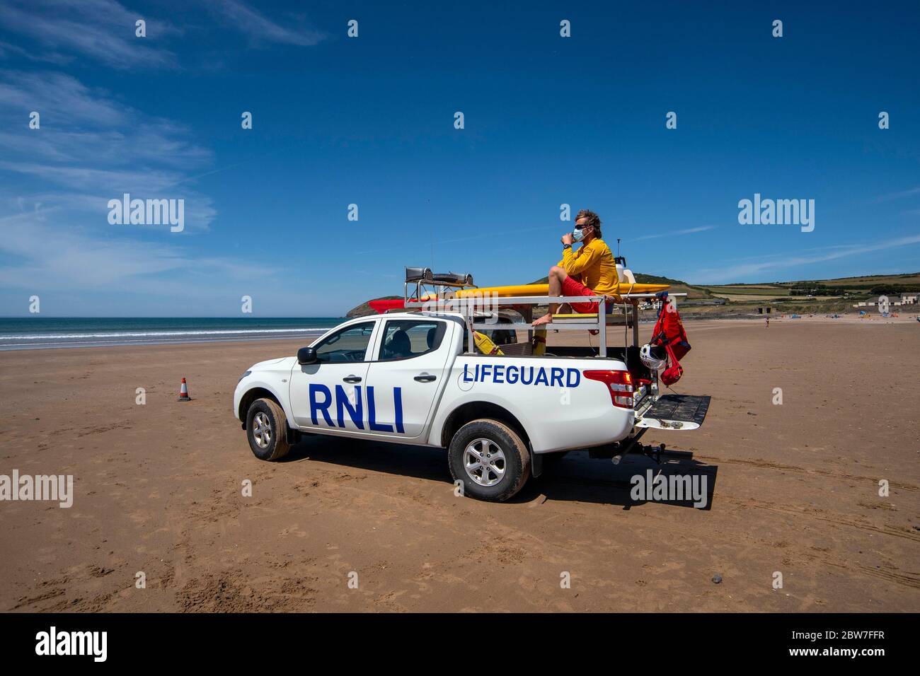 RNLI Lifeguards resume patrols on the beach at Croyde in Devon wearing