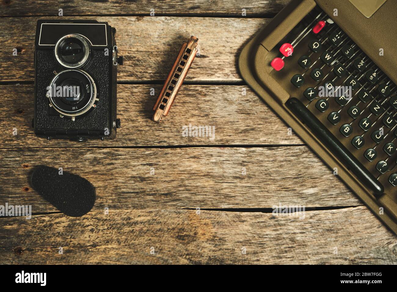Old retro typewriter, camera and typewriter on a wooden background Stock Photo