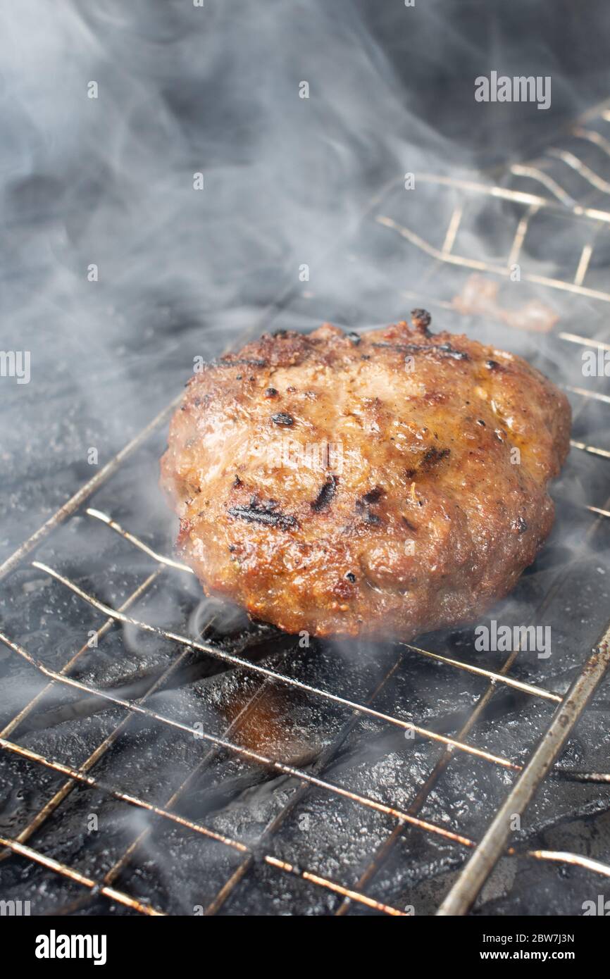 cooking burgers on hot grill with flames Stock Photo Alamy